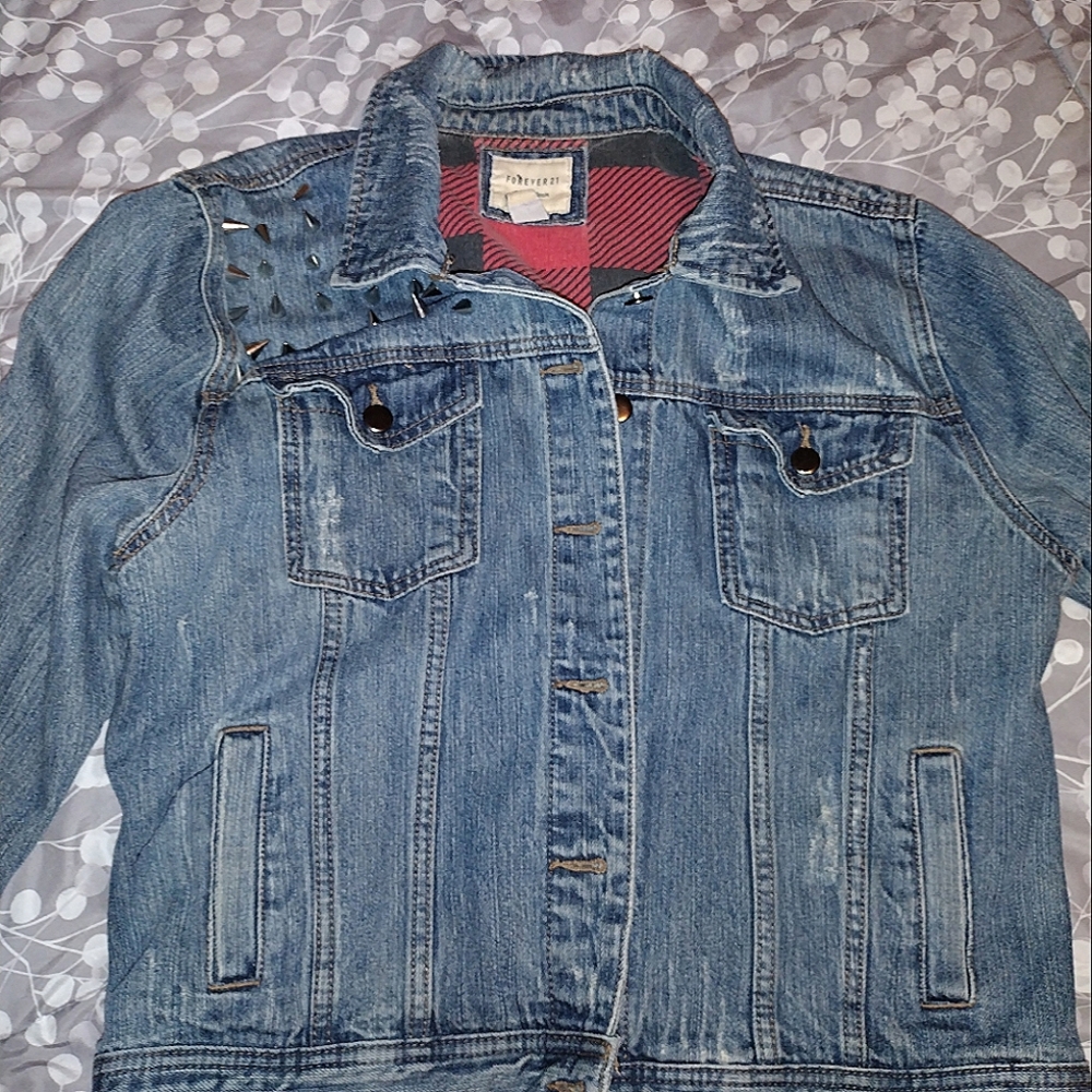 Denim jacket with silver spikes on right front lapel